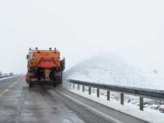 Snow plow machine working on the road
