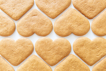 Rows of heart shaped cookies viewed from above