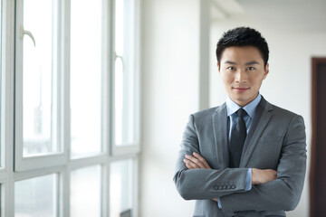 Portrait of young business man in corridor