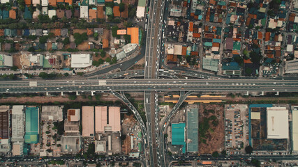 Top down cars drive at cross freeway in aerial view. Highway traffic transportation at Manila city on Luzon Island, Philippines, Asia. Wonderful cityscape of downtown centre