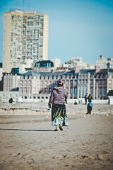 gypsy woman walking on the beach, Mar del Plata, Buenos Aires, Argentina