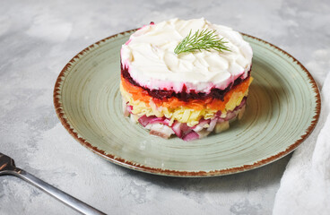 Russian traditional new year salad herring under fur coat on concrete table