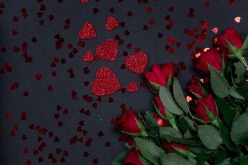 Red roses for the holiday on a dark background, Valentine's Day, March 8.