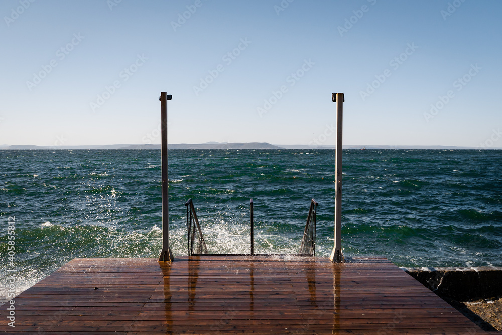 Wall mural wooden pier with sea background