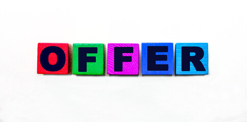 The word OFFER is written on colorful cubes on a light background