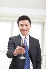 Portrait of businessman holding a glass of wine