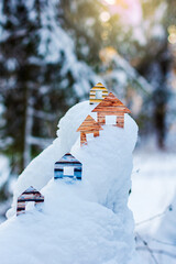 Conceptual paper houses in snow forest