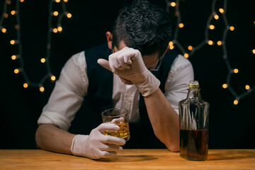 Barman pouring whiskey Waiter Discouraged during the COVID epidemic, no customers