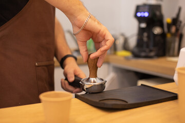 Fototapeta na wymiar Barista making coffee in coffeeshop.