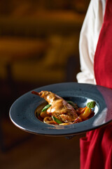 Tasty spicy rabbit stew in tomato sauce with white wine and herbs close-up. Horizontal top view from above