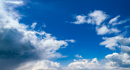 Blue sky with clouds in sunlight, wide cloudscape background panorama
