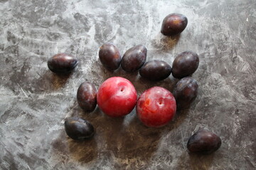 colorful plums, plums in two colors, round and oblong plums, colorful fruit,