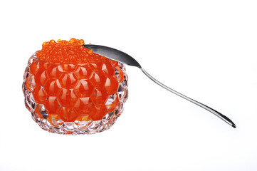 red caviar in a glass caviar bowl with a spoon standing next to it on a white isolated background
