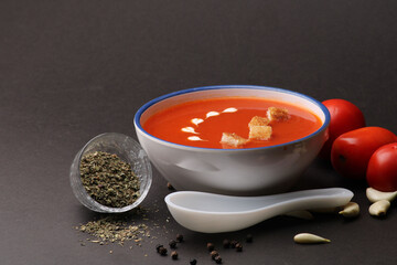 Tomato soup with croutons and fresh cream and tomatoes 