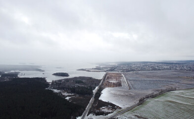 Fototapeta na wymiar Top view of a snowy landscape with a field