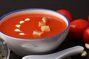 Tomato soup with croutons and fresh cream and tomatoes 