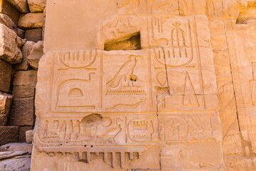 Egyptian hieroglyphs carved in stone. The Karnak Temple Complex, a vast mix of decayed temples,...