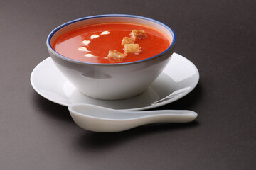 Tomato soup with croutons and fresh cream and tomatoes 