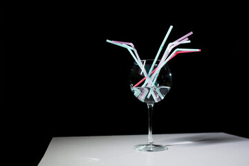 Wine glass with straws.