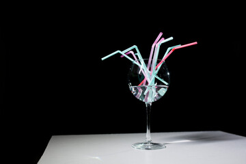 Wine glass with straws.