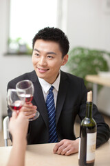 Portrait of businessman holding a glass of wine and toasting