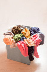 Pile of clothes in a large gray box. Recycling textiles