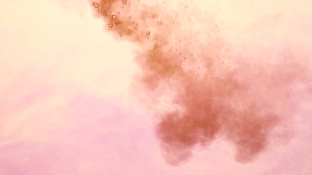 Violet and brown ink spreading in water on white. Abstract color background, liquid smoke, psychedelic and art concept.