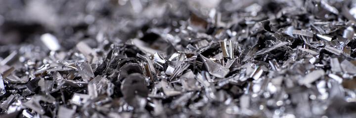 Metal shavings. Panoramic background of metallic chips. Processing of ferrous metals in a factory