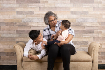 Happy moments with grandma, indian or asian senior lady spending quality time with her grand children 