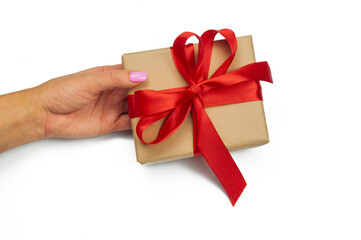 the girl is holding a gift box in her hand a surprise present with a tied red bow for St. valentine's day and birthday on a white background