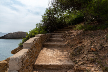 Old stairs leading up the cliff, coast line in South Europe