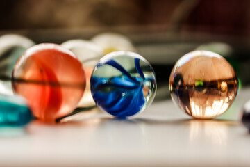 Three colorful transparent marbles, glass stones. Close up