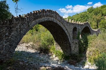 View of the traditional stone Kalouta Bridge in Epirus, Greece.