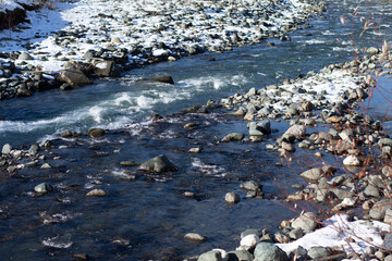 mountain river murmurs on a clear day
