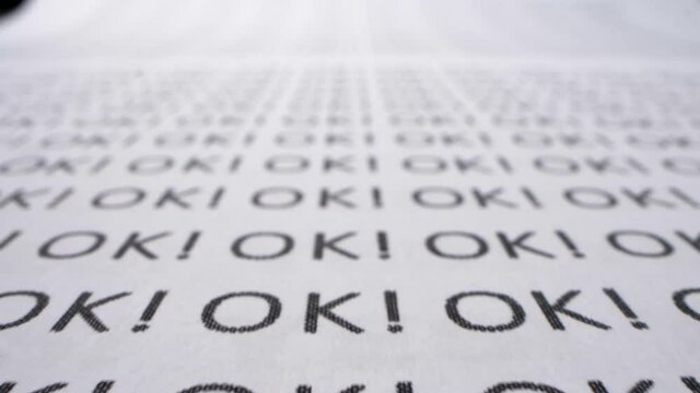 extreme close-up, detailed. text background. the word ok written many times on a white piece of paper.