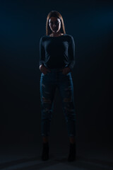 Silhouette picture of beautiful woman posing on black background