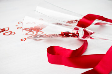 Happy Valentine's day on February 14, glasses with red hearts on a white background
