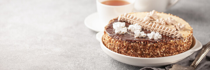 Cake with cream and a decor on a table, a dessert to tea. Selective focus.