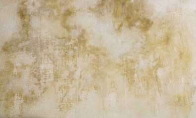 The texture of an old concrete wall with yellow divorces from the water. Beige grunge background