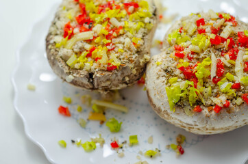 Mushrooms stuffed with onion, garlic, leek, paprika and sprinkled with cheese and breadcrumbs, snack prepared for baking