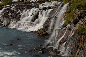 Fototapeta premium Hraunfossar waterfalls cascading into the Hvítá river over ledges of lava rock