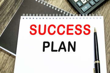 SUCCESS PLAN . THE TEXT IS WRITTEN IN A NOTEBOOK.