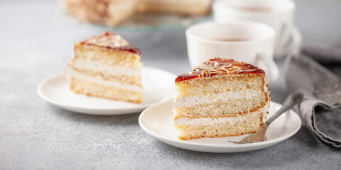 Cake with cream and a decor on a table, a dessert to tea. Selective focus.