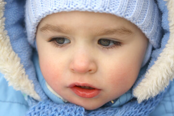 happy little boy in winter clothes, close-up portrait