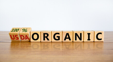 100 percent organic symbol. Fliped wooden cubes and changed words USDA organic to 100 percent organic. Beautiful white background, copy space. Business, healthy lifestyle organic concept.