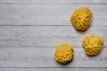 Fototapeta na wymiar Natural bath sponges at bright gray background flat lay top view.
