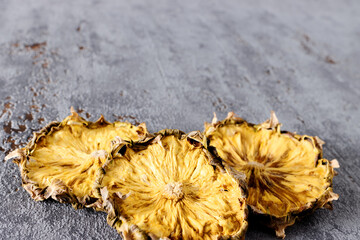 Slices of dried pineapple Organic fruits dehydrated at home. Copy space.