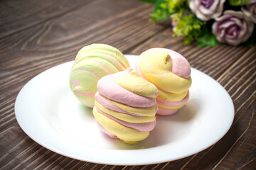 Homemade gentle apple and berry marshmallows on a white plate. Homemade healthy sweets. A lot of...