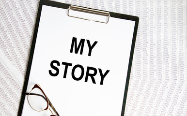 On the letter tablet, the text of MY STORY, next to the glasses and background are reports.