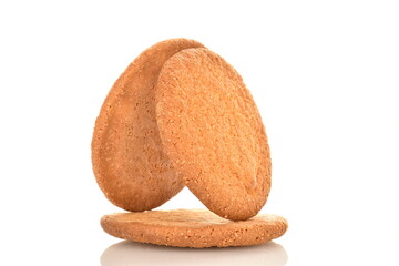 Three freshly baked round American cookies, close-up, isolated on white.